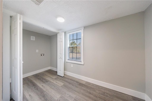 141 Nathan Rd, Atlanta, GA 30331 - below grade area with wood finished floors, baseboards, and a textured ceiling