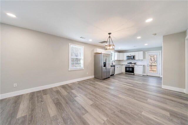 141 Nathan Rd, Atlanta, GA 30331 - unfurnished living room with light wood finished floors, baseboards, and recessed lighting