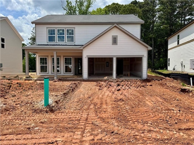 view of front of house featuring a porch, driveway, and a garage