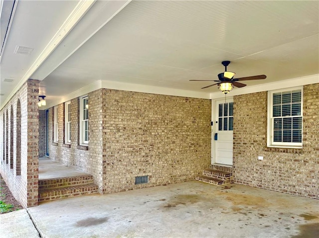 property entrance with a ceiling fan, crawl space, brick siding, and visible vents