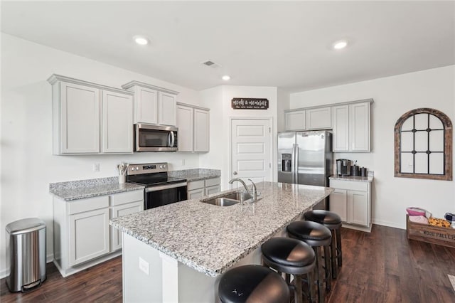 29 Gaston Ct, Hoschton, GA 30548 - kitchen with appliances with stainless steel finishes, a sink, a kitchen breakfast bar, light stone countertops, and recessed lighting