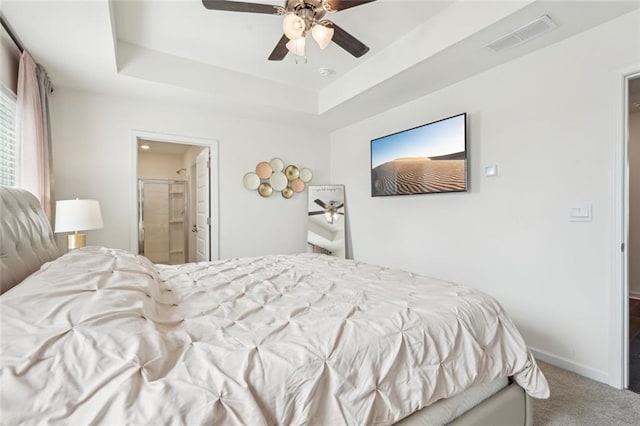 29 Gaston Ct, Hoschton, GA 30548 - bedroom with carpet floors, baseboards, a ceiling fan, a tray ceiling, and ensuite bathroom