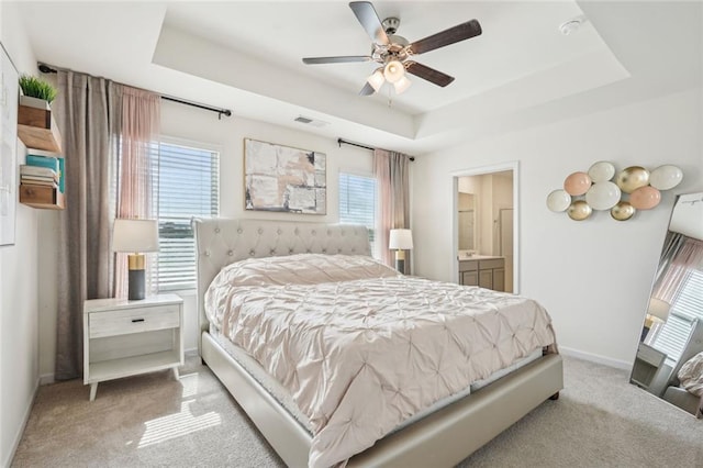 29 Gaston Ct, Hoschton, GA 30548 - carpeted bedroom featuring a raised ceiling, baseboards, ensuite bathroom, and a ceiling fan