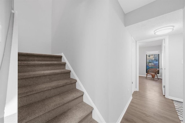 stairs featuring hardwood / wood-style floors