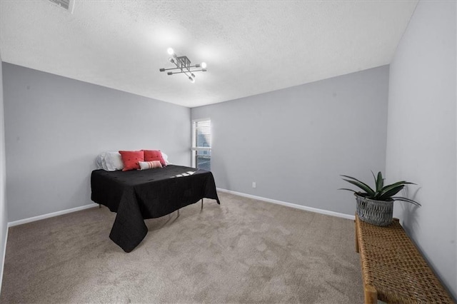 carpeted bedroom featuring a textured ceiling