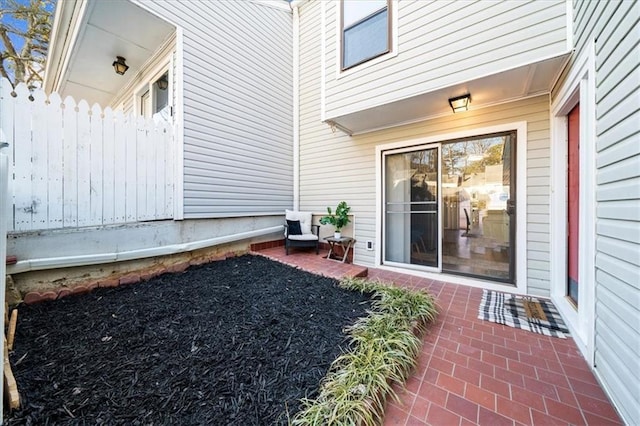 doorway to property with a patio area and fence