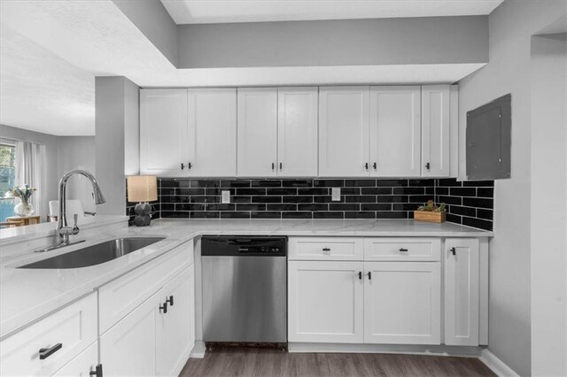 kitchen featuring dishwasher, sink, and white cabinets