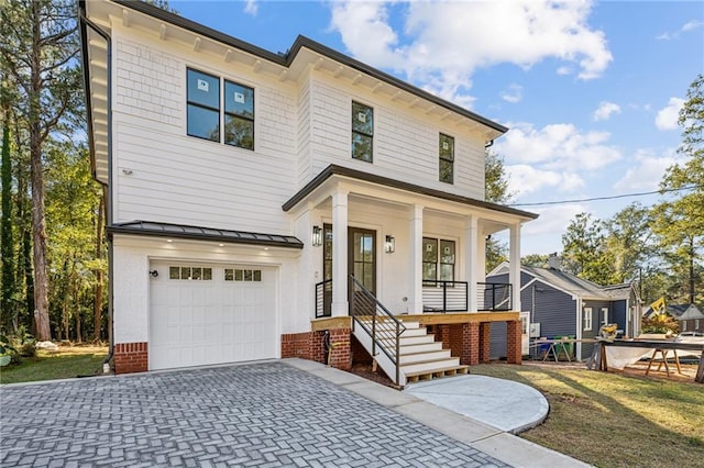 view of front of property with covered porch and a garage