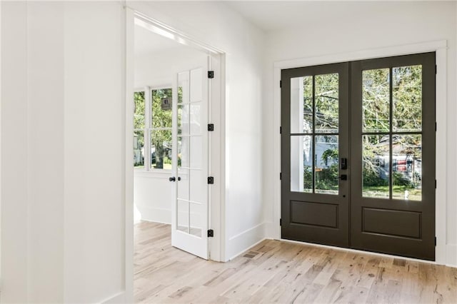 doorway featuring french doors and light wood-type flooring