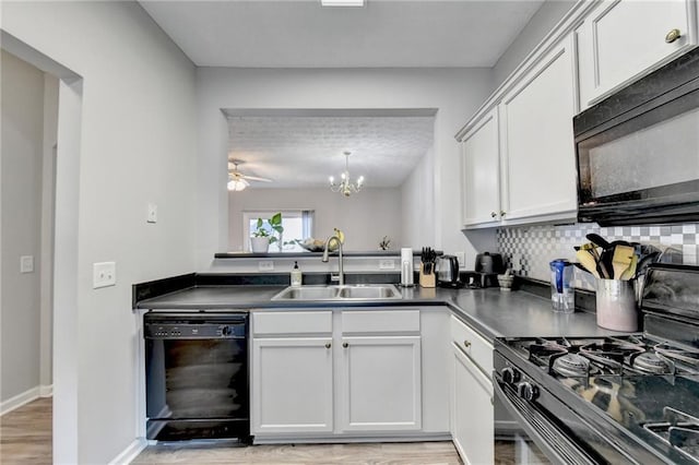 kitchen featuring black appliances, light hardwood / wood-style floors, sink, and white cabinets