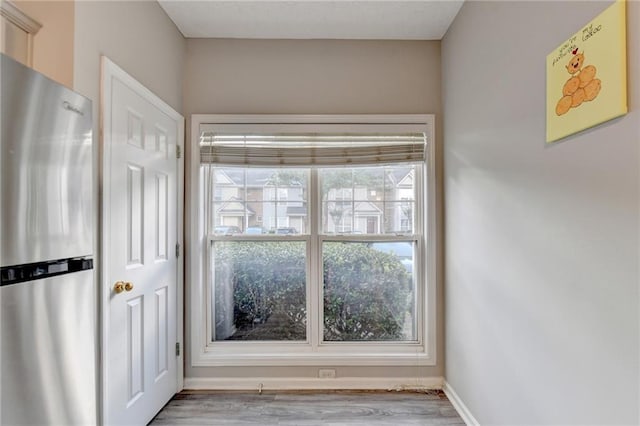 doorway with light wood-type flooring