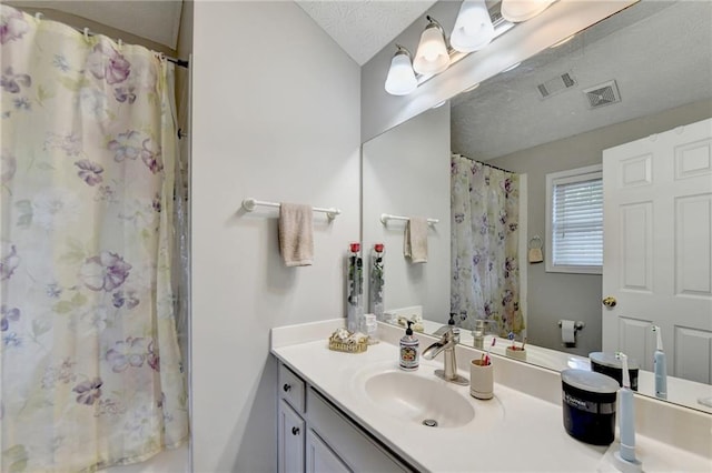 bathroom featuring vanity and a textured ceiling