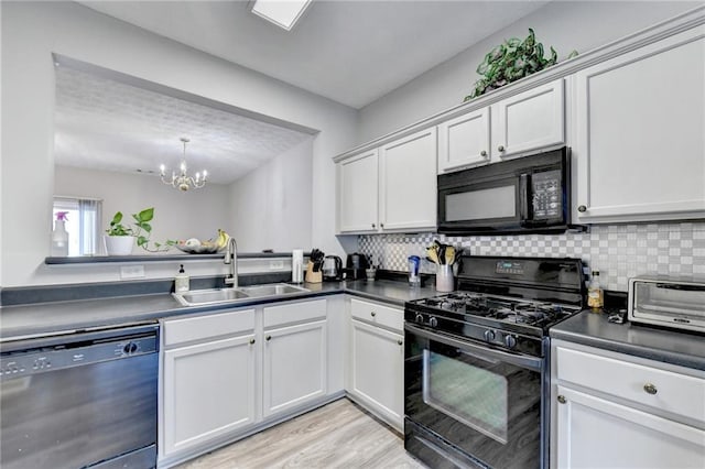 kitchen with black appliances, light hardwood / wood-style floors, white cabinetry, and sink