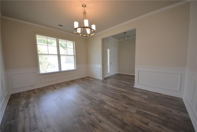 7753 Hansel Ln, Lithonia, GA 30058 - empty room featuring a chandelier, a wainscoted wall, dark wood-type flooring, crown molding, and a decorative wall