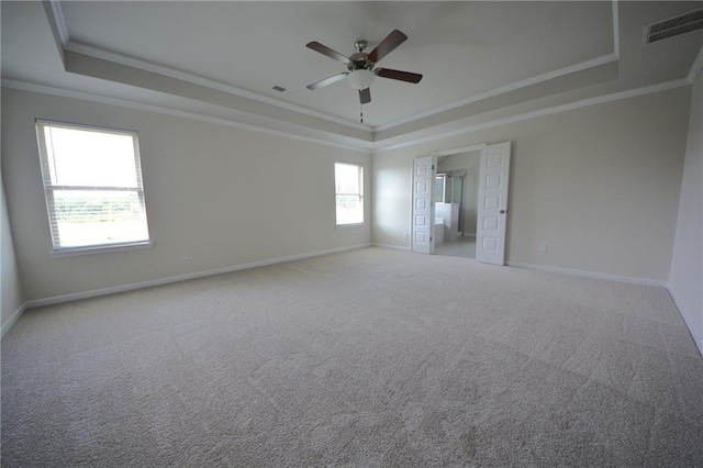 7753 Hansel Ln, Lithonia, GA 30058 - empty room featuring a tray ceiling, ornamental molding, a ceiling fan, and carpet floors