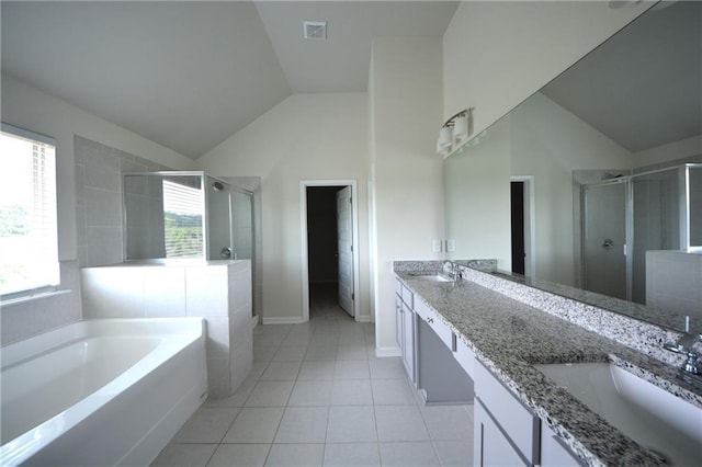 7753 Hansel Ln, Lithonia, GA 30058 - full bath with vaulted ceiling, a stall shower, a garden tub, double vanity, and tile patterned flooring