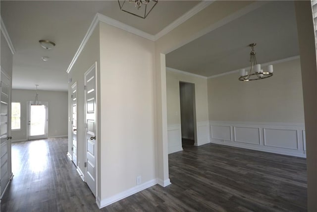 7753 Hansel Ln, Lithonia, GA 30058 - hallway with a chandelier, dark wood-style flooring, and crown molding