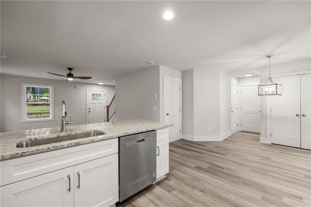 kitchen featuring dishwasher, white cabinets, sink, ceiling fan, and light stone countertops