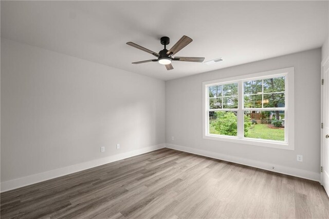 empty room featuring hardwood / wood-style floors and ceiling fan