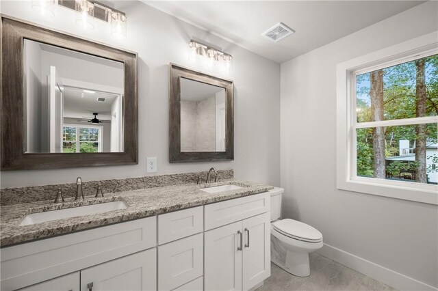 bathroom featuring tile patterned flooring, ceiling fan, toilet, and vanity