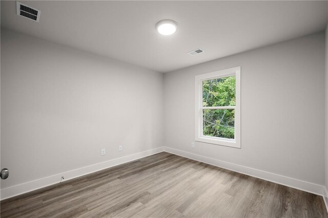 spare room with wood-type flooring