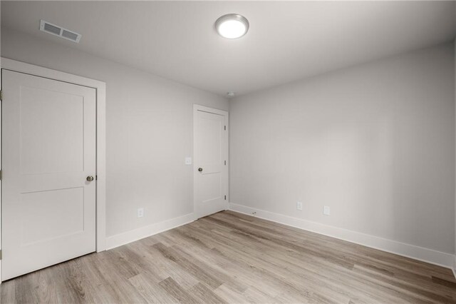 spare room featuring light hardwood / wood-style flooring