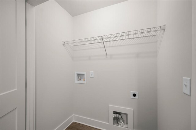 washroom with hookup for an electric dryer, washer hookup, and hardwood / wood-style flooring