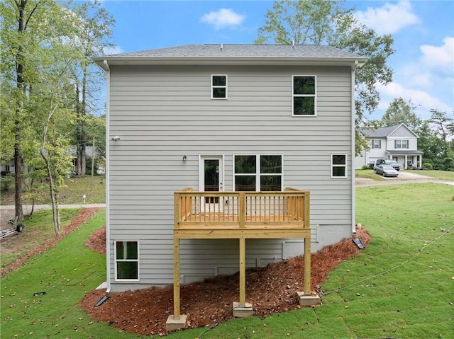 back of house with a lawn and a deck