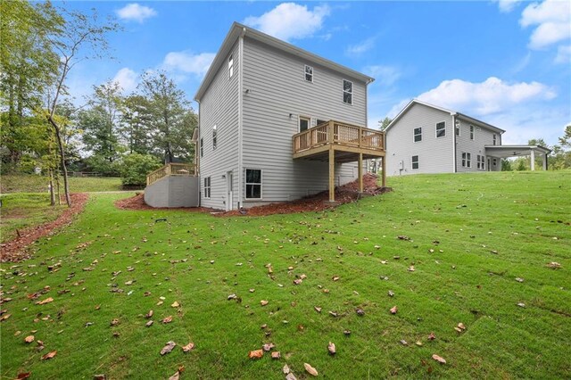 back of house with a yard and a deck