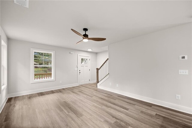 unfurnished room with ceiling fan and light hardwood / wood-style flooring