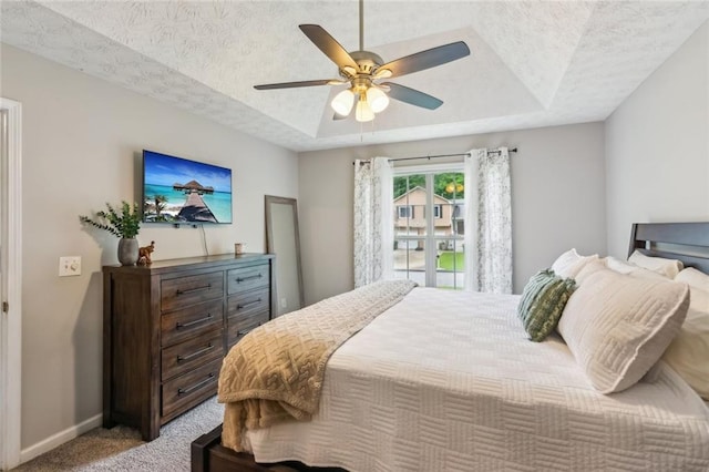 5519 Princeton Oaks Ln, Sugar Hill, GA 30518 - bedroom featuring a tray ceiling, a ceiling fan, and baseboards