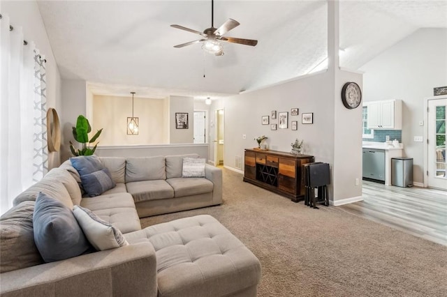 5519 Princeton Oaks Ln, Sugar Hill, GA 30518 - carpeted living room featuring a ceiling fan, a fireplace with flush hearth, baseboards, and high vaulted ceiling