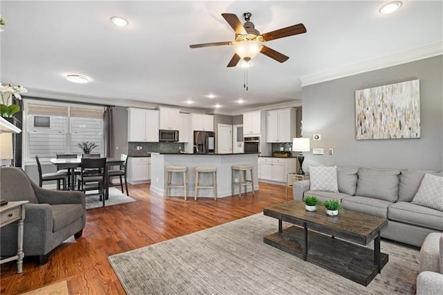 1604 Gilstrap Ln NW, Atlanta, GA 30318 - living area with ornamental molding, ceiling fan, recessed lighting, and light wood finished floors