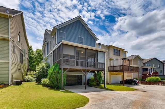 1604 Gilstrap Ln NW, Atlanta, GA 30318 - view of front of home with a sunroom, a garage, driveway, and a front lawn