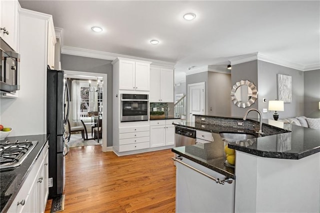 1604 Gilstrap Ln NW, Atlanta, GA 30318 - kitchen with appliances with stainless steel finishes, crown molding, light wood-type flooring, white cabinets, and recessed lighting