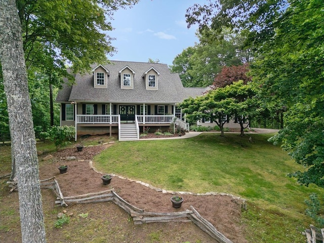 cape cod-style house with a front yard and covered porch