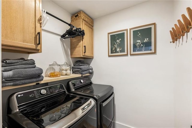 washroom featuring cabinet space and washer and dryer