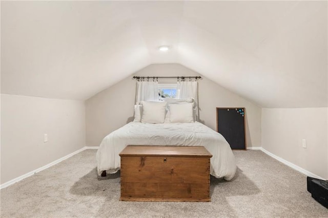 bedroom with carpet flooring, lofted ceiling, and baseboards