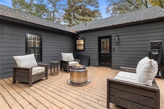 wooden terrace with an outdoor fire pit