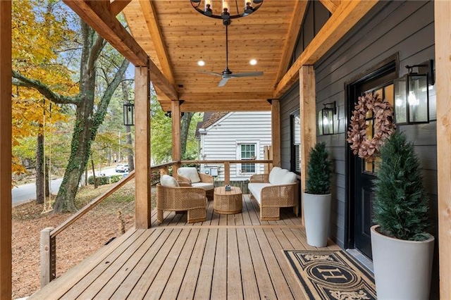 wooden deck featuring an outdoor hangout area and a ceiling fan