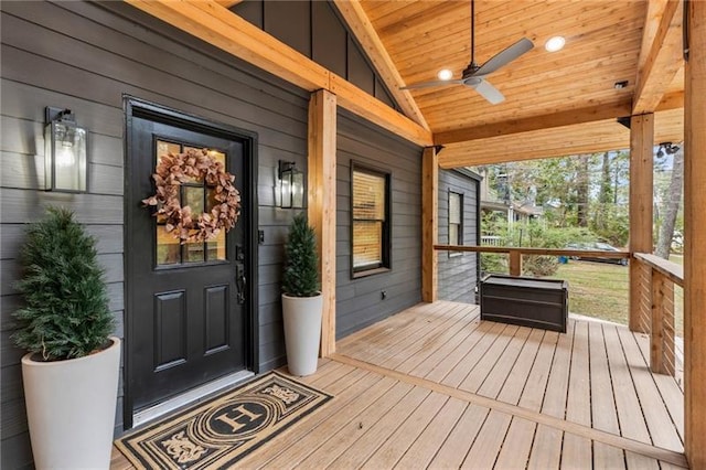 view of exterior entry featuring a ceiling fan and covered porch