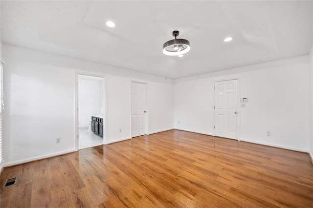 unfurnished room with recessed lighting, visible vents, and baseboards