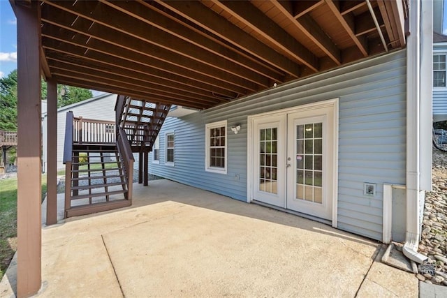 view of patio / terrace featuring french doors and stairs