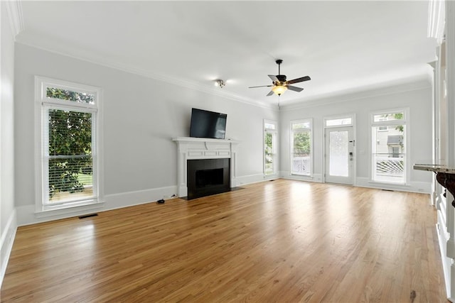 4011 Charrwood Trce, Marietta, GA 30062 - unfurnished living room featuring plenty of natural light, a fireplace with flush hearth, crown molding, a ceiling fan, and light wood-type flooring