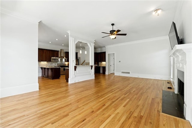 4011 Charrwood Trce, Marietta, GA 30062 - unfurnished living room with ceiling fan, a fireplace with flush hearth, stairway, light wood-style floors, and ornamental molding
