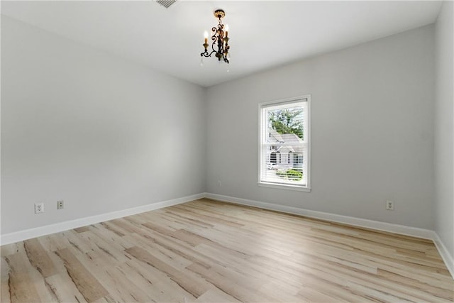 4011 Charrwood Trce, Marietta, GA 30062 - spare room with light wood finished floors, a chandelier, and baseboards