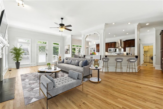 4011 Charrwood Trce, Marietta, GA 30062 - living room with ornamental molding, a ceiling fan, light wood-style floors, washer / clothes dryer, and baseboards