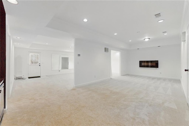 4011 Charrwood Trce, Marietta, GA 30062 - unfurnished living room with a tray ceiling, light colored carpet, recessed lighting, a glass covered fireplace, and baseboards