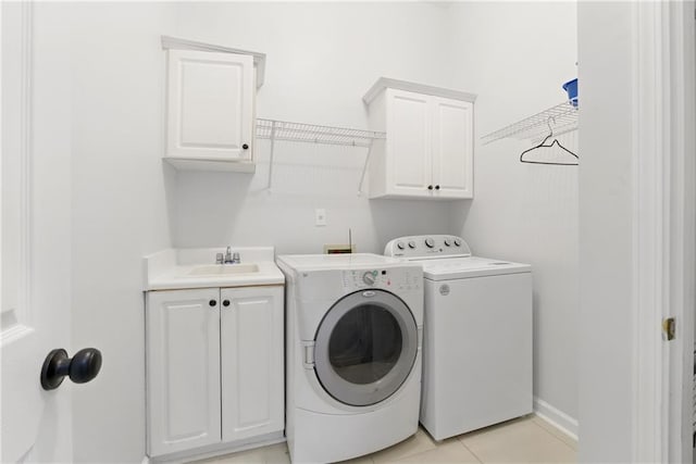 4011 Charrwood Trce, Marietta, GA 30062 - laundry area featuring cabinet space, washing machine and dryer, baseboards, and light tile patterned flooring