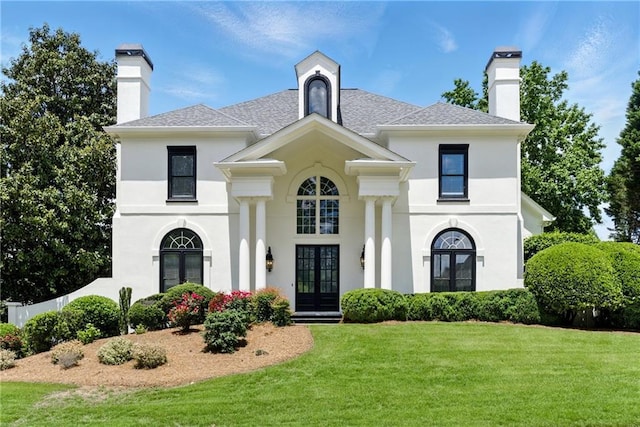 4011 Charrwood Trce, Marietta, GA 30062 - view of front of house featuring french doors, a front lawn, a chimney, stucco siding, and roof with shingles